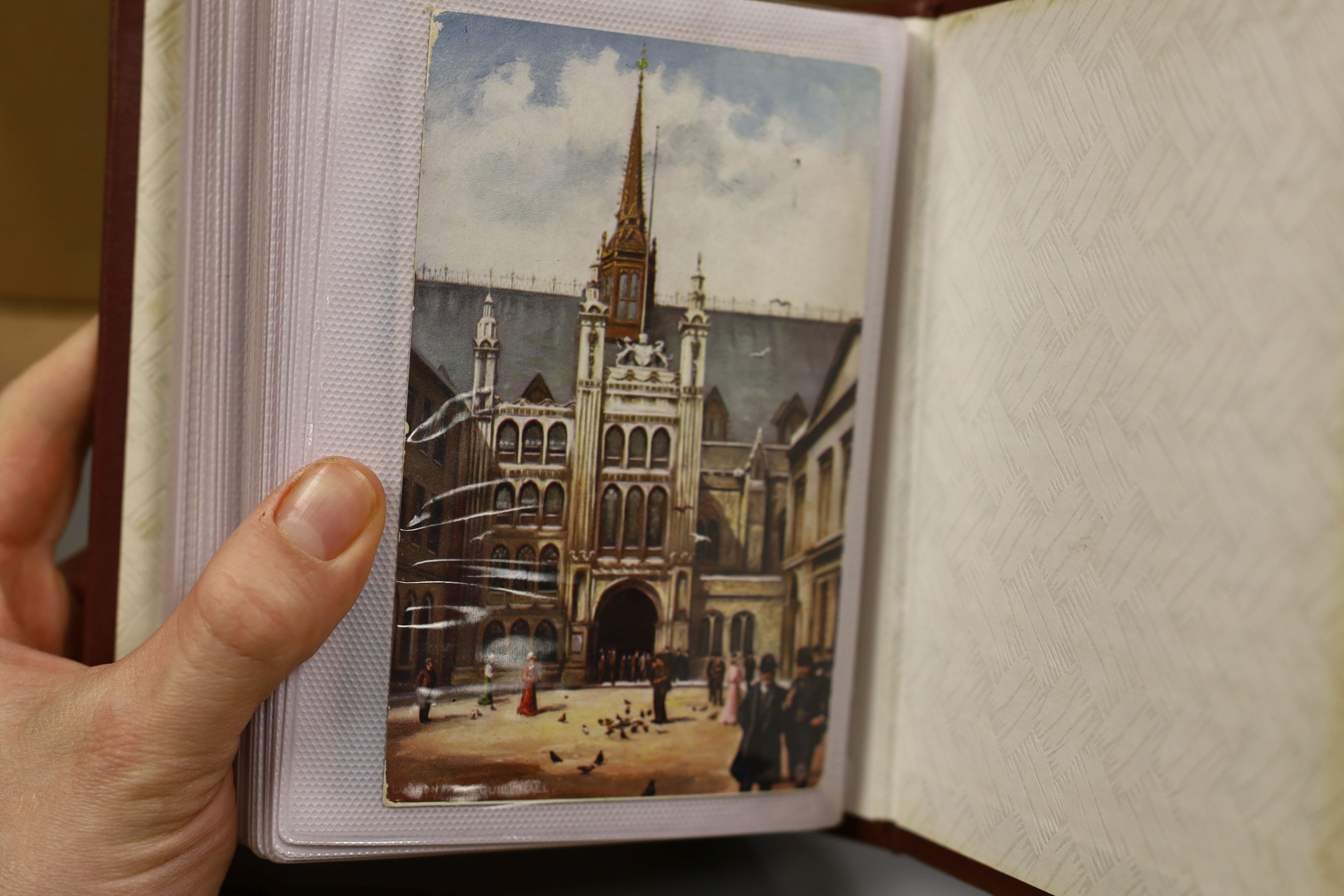 A quantity of Edwardian and later postcards, in nine modern albums